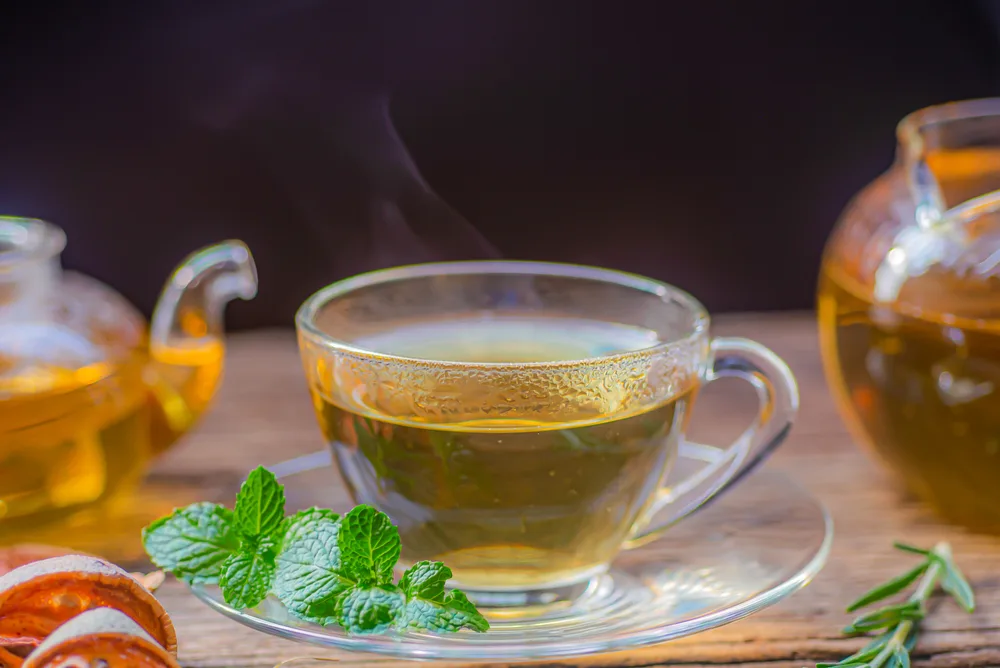 Hot,Tea,In,Glass,Teapot,And,Cup,With,Peppermint. peppermint tea